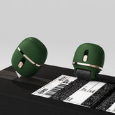 Two green office supplies on a black surface with a white background