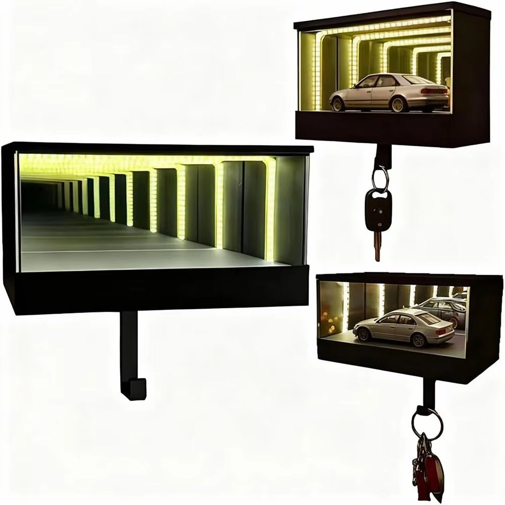 Three black rectangular light boxes with keychains attached, displaying different scenes.